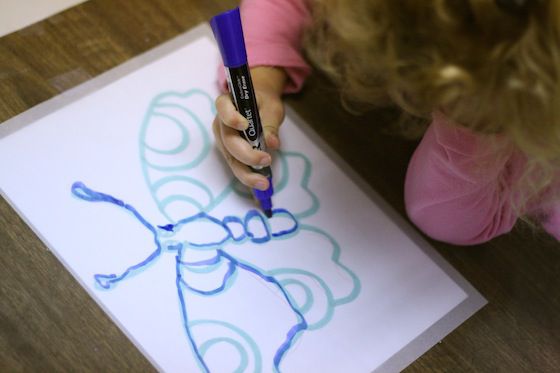 A child tracing letters on paper. You gotta learn to code somewhere.